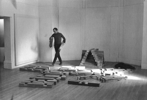 Carl Andre building 'Cedar Piece', 1964